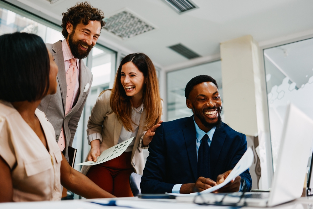 Multi-ethnic,Business,Team,Laughing,While,Working,Together,In,Modern,Office